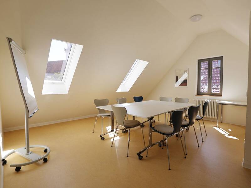 Familienzentrum Metzingen, Besprechungsecke im 2. Obergeschoss mit Tischen, Stühlen und Flipchart